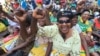 FILE: Women chant party slogans upon the arrival of Zimbabwean President Robert Mugabe for a crucial Zanu PF Poltiburo meeting in Harare, Wednesday Feb. 10, 2016. Mugabe addressed thousand of party supporters and chaired a bitterly divided Zanu pf Politiburo amid heightened tensions over issues to do with factionalism and succession in the party.(AP Photo/Tsvangirayi Mukwazhi)