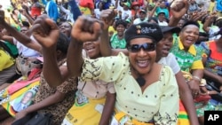 FILE: Women chant party slogans upon the arrival of Zimbabwean President Robert Mugabe for a crucial Zanu PF Poltiburo meeting in Harare, Wednesday Feb. 10, 2016. Mugabe addressed thousand of party supporters and chaired a bitterly divided Zanu pf Politiburo amid heightened tensions over issues to do with factionalism and succession in the party.(AP Photo/Tsvangirayi Mukwazhi)