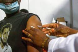 FILE - A nurse injects a patient with a dose of AstraZeneca vaccine in Abidjan, Ivory Coast, March 19, 2021.