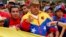 FILE - National Assembly President Diosdado Cabello (C) take part in a rally with a Bolivarian militia in Caracas, March 15, 2014.