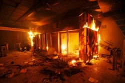 A subway ticket office is on fire during a protest against the increase in the ticket prices for buses and subways in Santiago, Chile, Oct. 19, 2019.