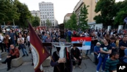 People attend a protest after arrest of the Serbian Orthodox Church priests in Montenegro, in Belgrade, Serbia, Thursday, May 14, 2020.
