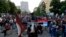 People attend a protest after arrest of the Serbian Orthodox Church priests in Montenegro, in Belgrade, Serbia, Thursday, May 14, 2020.