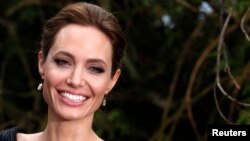 FILE - Actress Angelina Jolie arrives for a special Maleficent Costume Display at Kensington Palace in London, May 8, 2014. 