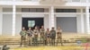 In this photo provided by Mandalay People's Defence, members of the Ta'ang National Liberation Army and Mandalay People's Defence Force pose for a photograph in front of a captured building in Nawnghkio township in Shan state, Myanmar, on June 26, 2024. 