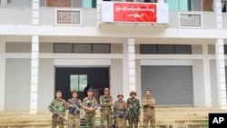 FILE - Members of the Ta'ang National Liberation Army and Mandalay People's Defense Force airs  for a photograph   successful  beforehand   of a captured gathering  successful  Nawnghkio township, Shan state, June 26, 2024. (Mandalay People's Defense Force via AP)