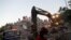 Rescue workers search for survivors at a collapsed building after an earthquake in Izmir