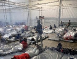 FILE - Detainees are seen in a Customs and Border Protection (CBP) temporary overflow facility in Donna, Texas, March 20, 2021, in this photo provided by the Office of Rep. Henry Cuellar, D-Texas.