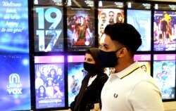 Saudi movie viewers wear face masks to help curb the spread of the coronavirus, at VOX Cinema hall in Jiddah, Saudi Arabia, June 26, 2020.