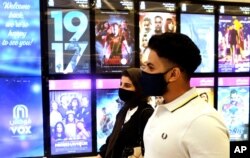 Saudi movie viewers wear face masks to help curb the spread of the coronavirus, at VOX Cinema hall in Jiddah, Saudi Arabia, June 26, 2020.