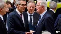 French Prime Minister, Michel Barnier (R) shakes hands with Ile-de-France region Prefect, Marc Guillaume (L), ahead of his visit at the Necker hospital in Paris, Sept. 7, 2024.