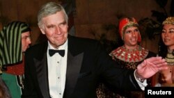  FILE - Actor Charlton Heston poses for photographers as he arrives for the grand re-opening of the American Cinematheque's Egyptian Theatre in Hollywood in this undated photo. Heston starred in "The Ten Commandments" by Cecil B. DeMille.