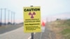 FILE - A caution sign stands on the Hanford Nuclear Reservation in the U.S. state of Washington, June 2, 2022. At least 12 workers at the site have been laid off as part of the Trump administration's downsizing of the federal workforce.