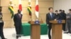 FILE: Japanese Prime Minister Shinzo Abe and Zimbabwe President Robert Mugabe.