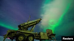 FILE PHOTO: The northern lights glow behind a Patriot missile M903 launcher station in Alaska