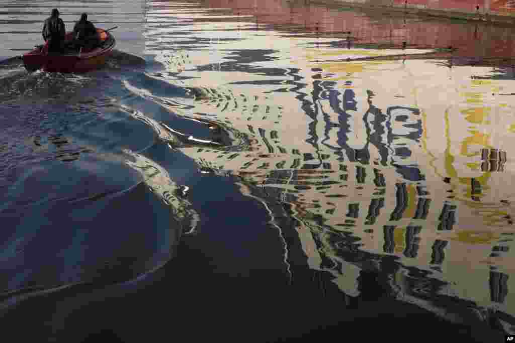 An immobilized ferry is reflected in the sea as a small boat sails in the Athens&#39; main port of Piraeus. Greek seamen have extended an anti-austerity 48-hour strike for a further 48 hours, halting island ferry services, as bailout-reliant Greece is planning to drastically overhaul its troubled pension and social security system, among other reforms.