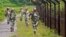 FILE - Female personnel of India's Border Security Force patrol along the fencing of the India-Bangladesh international border ahead of India's Independence Day celebrations, at Dhanpur village in India's northeastern state of Tripura, August 2014.
