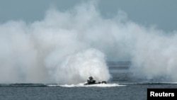 FILE - Philippine and U.S. navies participate in amphibious landing drills during a joint military exercise at a naval station in Zambales province, Philippines, Oct. 7, 2022. 