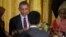 President Barack Obama sits with guests during the annual Iftar dinner, celebrating the Muslim holy month of Ramadan, in the East Room of the White House, June 22, 2015, in Washington. 