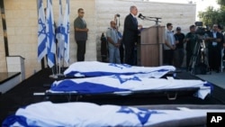 Israeli Prime Minister Benjamin Netanyahu eulogizes three Israeli teens who were abducted and killed in the West Bank during their joint funeral in Modiin, July 1, 2014.