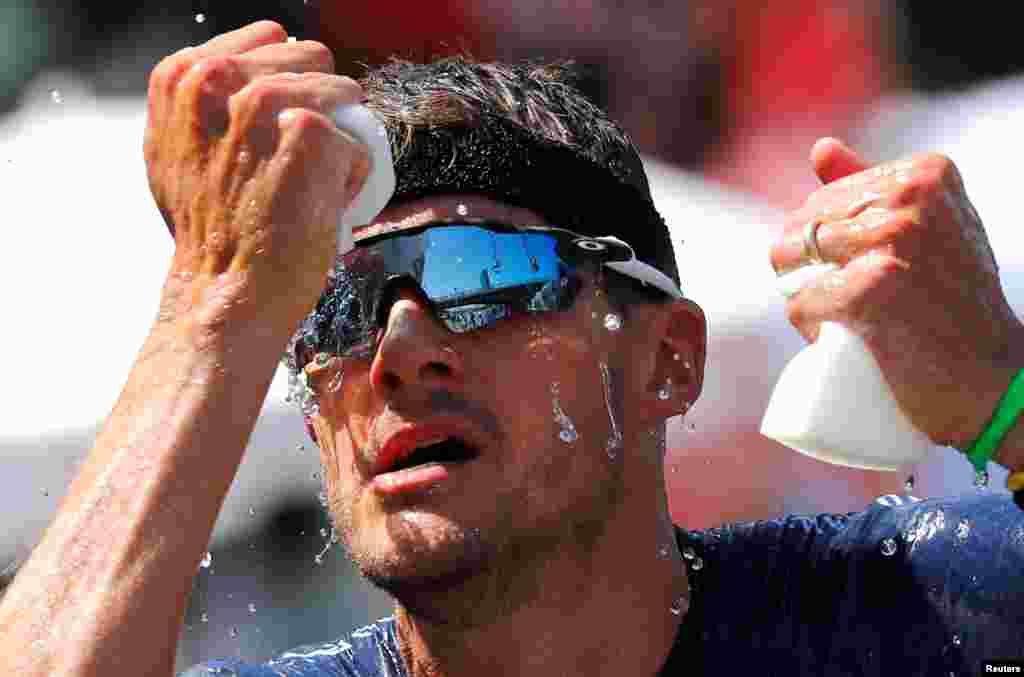 Triathlete Jan Frodeno of Germany tries to cool down on his way to win the Ironman triathlon European Championships in Frankfurt, Germany.