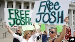 People show their support for Josh Holt, an American jailed in Venezuela, during a rally at the Utah State Capitol, July 30, 2016, in Salt Lake City. Laurie Holt says her son was mistakenly accused. Josh Holt was arrested on suspicion of weapons charges after he traveled to Venezuela on a tourist visa to marry a fellow Mormon he met on the internet. 