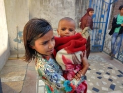 Girls stay behind to help their mothers with housework and to look after siblings. (Anjana Pasricha/VOA)