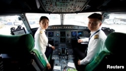 Captain Han Siyuan, 30, poses in the cockpit of Spring Airlines' Airbus A320 before taking off at Hongqiao International Airport in Shanghai, China, Oct. 18, 2018. 