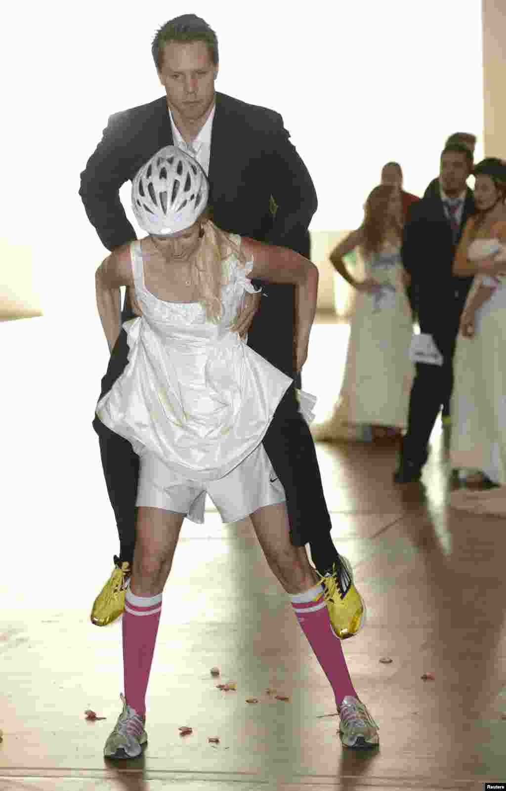 Elina and Jukka (top) compete in the Wedding Run competition, which is held at the "I Love Me" fair, in Helsinki, Finland. The competition is for couples planning to get married.