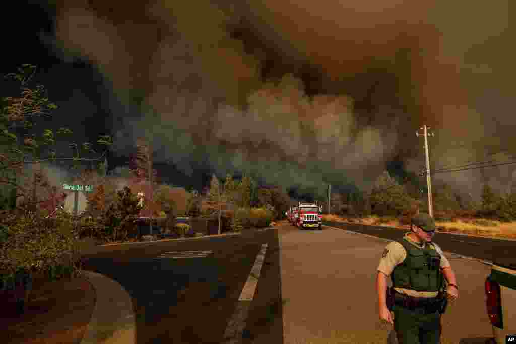 The Camp Fire rages through Paradise, Calif., Nov. 8, 2018. Tens of thousands of people fled a fast-moving wildfire Thursday in Northern California, some clutching babies and pets as they abandoned vehicles and struck out on foot.