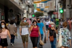 People wearing face masks to prevent the spread of coronavirus walk in downtown Madrid, Spain, Sept. 16, 2020.