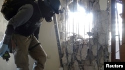A UN chemical weapons expert inspects one of the sites of a chemical weapons attack in a Damascus' suburb.