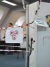 Kosovo electoral commission staff sit at a polling station in the town of Zvecan on April 21, 2024.