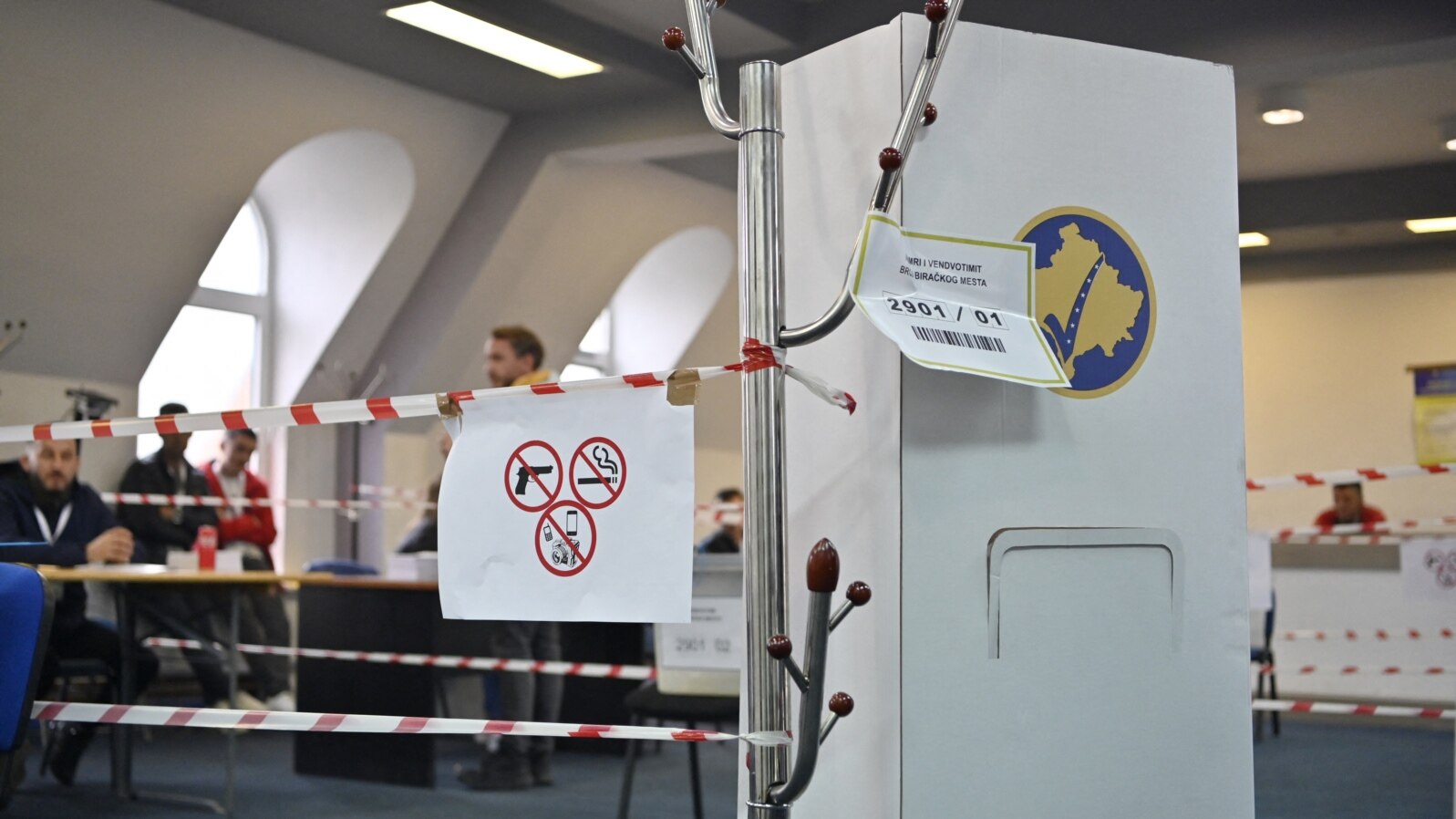 Kosovo electoral commission staff sit at a polling station in the town of Zvecan on April 21, 2024.