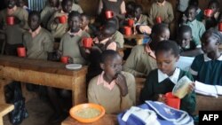 FILE - Pupils at the Stara primary school in Nairobi's Kibera slum eat a meal provided by the World Food Program (WFP), May 26, 2009, as part of a school feeding program. 