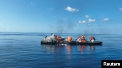 (FILE) Explosions take place on the deck of the Greek-flagged oil tanker Sounion on the Red Sea, in this handout picture released August 29, 2024. 