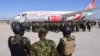 Kenyan police officers arrive at Toussaint Louverture International Airport in Port-au-Prince, Haiti, Jan. 18, 2025. The officers are part of a multinational force that aims to curb gang violence in Haiti.