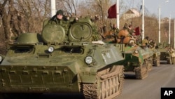 FILE - Pro-Russia rebels are seen driving in a convoy in Stakhanov, eastern Ukraine, April 24, 2015. 