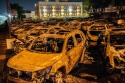 The remains of the cars burned by protesters the previous night during a demonstration against the shooting of Jacob Blake are seen on a used cars lot in Kenosha, Wis., on Aug. 26, 2020.