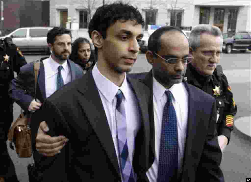 Dharun Ravi, center, is helped by his father, Ravi Pazhani, second right, as they leave court around in New Brunswick, N.J., Friday, March 16, 2012. Defense attorney Philip Nettl follows, second left. Ravi, a former Rutgers University student accused of