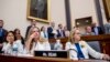 From left, Rep. Veronica Escobar, D-Texas, Rep. Debbie Mucarsel-Powell, D-Fla., and Rep. Madeleine Dean, D-Pa., wear white and yellow roses to commemorate the 19th Amendment on Capitol Hill in Washington, Tuesday, May 21, 2019.