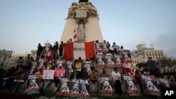 Demonstrators hold posters with a message that reads in Spanish; "Reject the Narco State, reject Keiko," during a protest against presidential candidate Keiko Fujimori, at Plaza San Martin in downtown Lima, Peru, May 31, 2016.