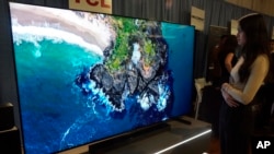 A 249-centimeter TCL QM-8 Q-Class Mini-LED QLED 4K HDR Smart TV is displayed at the Pepcom Holiday Spectacular event, in New York, Oct. 30, 2024.