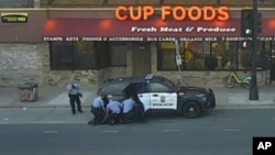 In this May 25, 2020 file image from surveillance video, Minneapolis police Officers from left, Tou Thao, Derek Chauvin, J. Alexander Kueng and Thomas Lane are seen attempting to take George Floyd into custody in Minneapolis, Minn. (Court TV via AP, Pool,