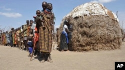 Turkana people wait in a line to receive food from Oxfam in central Turkana district, Kenya in August 2011. The U.N. says tens of thousands of people died in Somalia, Kenya, Ethiopia and Djibouti from famine. Five years later, drought has returned. 