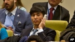 FILE - Shin Dong-Hyuk holds his earpiece as he listens during a meeting of the U.N. General Assembly human rights committee on a proposal to refer North Korea to the International Criminal Court for alleged crimes against humanity, Nov. 18, 2014.