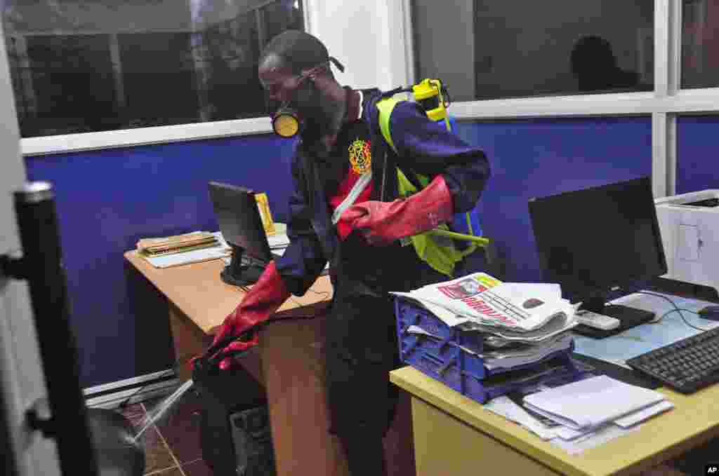 An employee of the Monrovia City Corporation sprays disinfectant inside a government building to prevent the spread of the deadly Ebola virus, Monrovia, Liberia, &nbsp;August 1, 2014.&nbsp;