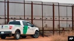 FILE - A U.S. Border Patrol vehicle drives next to a U.S.-Mexico border fence in the New Mexico town of Santa Teresa, Jan. 5, 2016. The Trump administration is preparing to replace existing vehicle barriers along a stretch of the border. The notice published Jan. 22, 2018, in the Federal Register says the area extends around 20 miles west of the Santa Teresa Port of Entry.