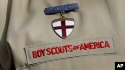 FILE - A detail of a Boy Scout uniform in front of the Boy Scouts of America headquarters in Irving, Texas, Feb. 4, 2013.