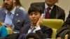 FILE - Shin Dong-Hyuk holds his earpiece as he listens during a meeting of the U.N. General Assembly human rights committee on a proposal to refer North Korea to the International Criminal Court for alleged crimes against humanity, Nov. 18, 2014.